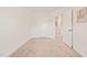 Neutral bedroom featuring tan carpet, white walls, with an ensuite entryway and door at 1137 Amber Shadow Dr, Durham, NC 27703