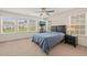 Bedroom with many windows for natural light, ceiling fan, and cozy carpet at 1137 Amber Shadow Dr, Durham, NC 27703