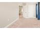 Neutral bedroom featuring tan carpet, white walls, and a visible ensuite entrance at 1137 Amber Shadow Dr, Durham, NC 27703