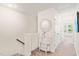 Hallway with carpet and decorative table with mirror and a small staircase on the left at 1137 Amber Shadow Dr, Durham, NC 27703