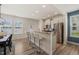 Bright kitchen features stainless steel appliances, granite countertops, and a breakfast bar with seating at 1137 Amber Shadow Dr, Durham, NC 27703