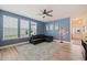Comfortable living room with large windows, ample natural light, and a ceiling fan at 1137 Amber Shadow Dr, Durham, NC 27703