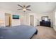Large bedroom features a fan, dresser and mirror, walk in closet and a view into the bathroom at 1137 Amber Shadow Dr, Durham, NC 27703