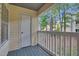 Outdoor balcony with white railing and view of trees at 117 Scott Ln, Chapel Hill, NC 27514