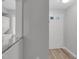 Condo entryway with gray walls, white trim, and a view of the washer/dryer unit at 117 Scott Ln, Chapel Hill, NC 27514