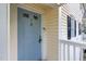 Close-up of a light blue front door with an ornate knocker and white trim at 117 Scott Ln, Chapel Hill, NC 27514
