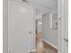 Condo hallway with gray walls, white trim, and laminate floors at 117 Scott Ln, Chapel Hill, NC 27514
