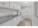 Well-lit kitchen with granite countertops, white cabinets, and appliances at 117 Scott Ln, Chapel Hill, NC 27514