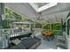 Back porch features a couch, table, dining area and screens with outdoor views of the backyard at 1205 Hillsborough Rd, Chapel Hill, NC 27516