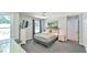 Well-lit bedroom with large windows, sleek carpet floors, and stylish bedside tables at 1205 Hillsborough Rd, Chapel Hill, NC 27516