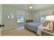Cozy bedroom with light blue bedding, simple decor, and ample natural light at 1205 Hillsborough Rd, Chapel Hill, NC 27516