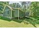 Back of a one-story home with a screened-in porch and green siding at 1205 Hillsborough Rd, Chapel Hill, NC 27516