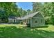 A charming single story home with a green yard and colorful flowers in the window boxes at 1205 Hillsborough Rd, Chapel Hill, NC 27516