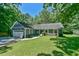 Charming single-story home with a well-manicured lawn, attached garage and flowering window boxes at 1205 Hillsborough Rd, Chapel Hill, NC 27516