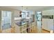 Bright kitchen features a central island, modern appliances, and hardwood floors at 1205 Hillsborough Rd, Chapel Hill, NC 27516
