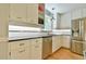 Modern kitchen with stainless steel appliances, white cabinets, and a subway tile backsplash at 1205 Hillsborough Rd, Chapel Hill, NC 27516