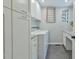 Functional laundry room with a washer, dryer, cabinets, and a folding counter at 1205 Hillsborough Rd, Chapel Hill, NC 27516