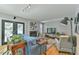Open-concept living room with stylish decor, fireplace, TV area and a view to the exterior patio at 1205 Hillsborough Rd, Chapel Hill, NC 27516