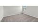 Bedroom has plush carpet, white walls, baseboards, and a bright window at 1250 Pond Overlook Dr, Nashville, NC 27856