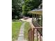 Lush backyard featuring a stone pathway, dining area, and a serene forested backdrop at 1320 Shepherd St, Durham, NC 27707