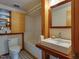 Well lit bathroom featuring an enclosed shower/tub and modern sink and mirror with stylish storage at 1320 Shepherd St, Durham, NC 27707