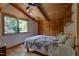 Cozy bedroom featuring hardwood floors, wooden beamed ceiling and ample closet space, illuminated by natural light at 1320 Shepherd St, Durham, NC 27707