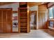 This bright bedroom features hardwood floors and an exposed beam ceiling with built-in shelving and closet space at 1320 Shepherd St, Durham, NC 27707