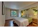 Comfortable bedroom featuring a decorative floral wall accent, a window and plenty of natural light at 1320 Shepherd St, Durham, NC 27707