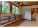 Sunlit bedroom offering large windows, hardwood floors, custom shelving, and views of the outdoor landscape at 1320 Shepherd St, Durham, NC 27707