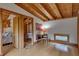 Bright bedroom boasts wood floors and ceiling, connecting to an adjacent room through an open doorway at 1320 Shepherd St, Durham, NC 27707