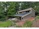 Back exterior of a well-maintained home with solar panels, a patio, lush landscaping, and an inviting outdoor space at 1320 Shepherd St, Durham, NC 27707