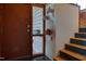 Welcoming foyer with wood door, decorative animal sconces, and an open staircase to the upper level at 1320 Shepherd St, Durham, NC 27707
