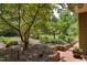 Serene landscaping featuring a Japanese maple, lush greenery, and brick accents along the walkway at 1320 Shepherd St, Durham, NC 27707