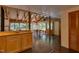 Inviting living area with exposed wooden beams, brick flooring, and large windows offering a lush view at 1320 Shepherd St, Durham, NC 27707