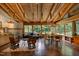 Spacious living area boasts exposed wooden beams, brick flooring, and natural light through large windows at 1320 Shepherd St, Durham, NC 27707