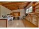This bright home office boasts hardwood floors, beamed ceilings, and a unique wood stove feature at 1320 Shepherd St, Durham, NC 27707