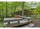 This outdoor seating area features a wooden deck, bench seating, and a table at 1320 Shepherd St, Durham, NC 27707