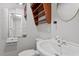 A clean bathroom features a unique mirrored wall and sink with brushed metal fixtures at 136 Dixie Ln, Youngsville, NC 27596