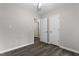 Spacious bedroom featuring wood-look floors, neutral paint, and a double closet at 136 Dixie Ln, Youngsville, NC 27596