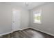 Comfortable bedroom with a closet, a window and wood-look flooring at 136 Dixie Ln, Youngsville, NC 27596