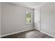 Cozy bedroom with natural light, wood-look flooring, and neutral paint at 136 Dixie Ln, Youngsville, NC 27596