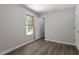 This bedroom features updated flooring, fresh paint, and natural light from the window at 136 Dixie Ln, Youngsville, NC 27596