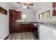 Convenient laundry room featuring dark cabinets, green countertops, and modern appliances at 136 Dixie Ln, Youngsville, NC 27596