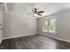 Living room features hardwood floors, ceiling fan, and large window views at 136 Dixie Ln, Youngsville, NC 27596