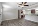 Open-concept room flows into a kitchen with sleek countertops and modern appliances at 136 Dixie Ln, Youngsville, NC 27596