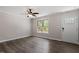 Bright living room with hardwood floors, a ceiling fan and a window providing natural light at 136 Dixie Ln, Youngsville, NC 27596