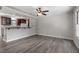 Living room with hardwood flooring flows into open kitchen and breakfast bar at 136 Dixie Ln, Youngsville, NC 27596