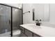 Modern bathroom with a sleek vanity, quartz countertop, matte black fixtures, and glass shower at 1417 Westmoreland Dr, Raleigh, NC 27612
