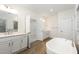 Well-appointed bathroom with dual sinks, a soaking tub, and modern fixtures at 1417 Westmoreland Dr, Raleigh, NC 27612