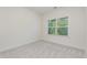 A carpeted bedroom features a window for natural light, perfect for a cozy and inviting space at 1417 Westmoreland Dr, Raleigh, NC 27612